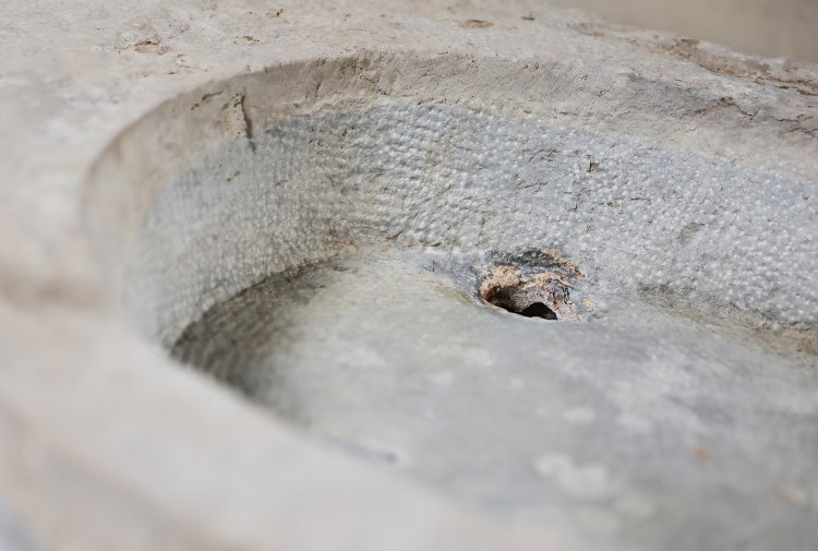 old sink of burgundy stone