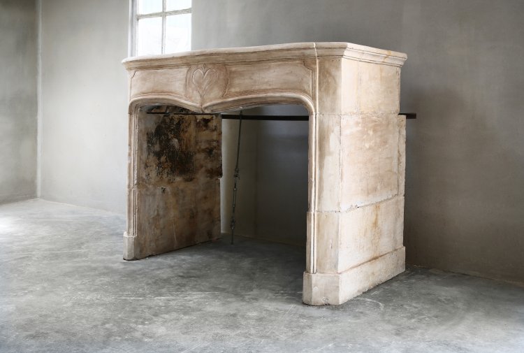 antique fireplace of french limestone