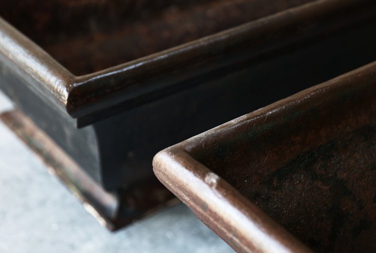 two identical antique troughs