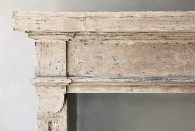 antique french fireplace of limestone