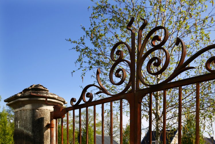 antique gate from iron and limestone